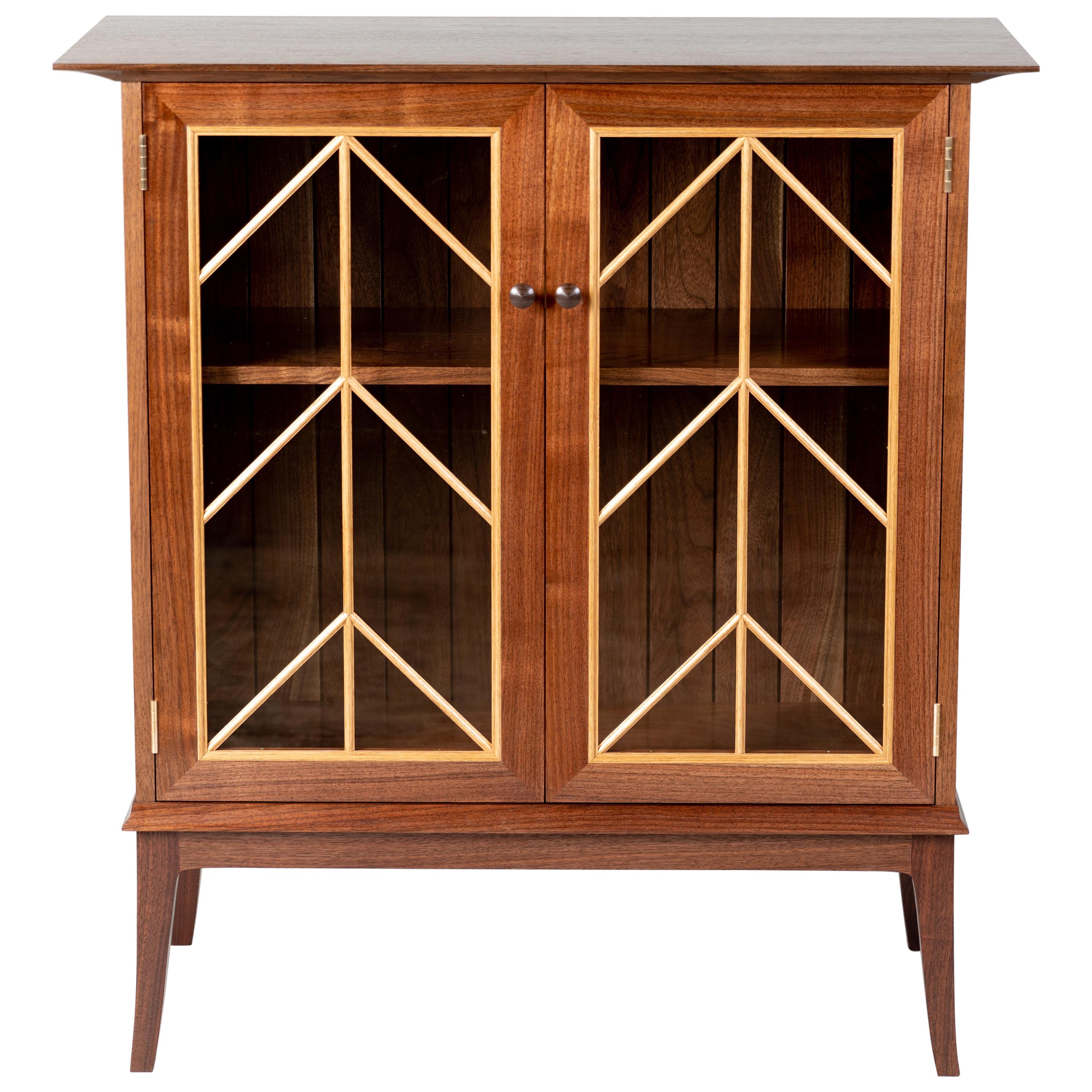 https://a.1stdibscdn.com/contemporary-walnut-cabinet-with-glass-doors-and-butternut-details-for-sale/1121189/f_166147721572020289389/16614772_master.jpg