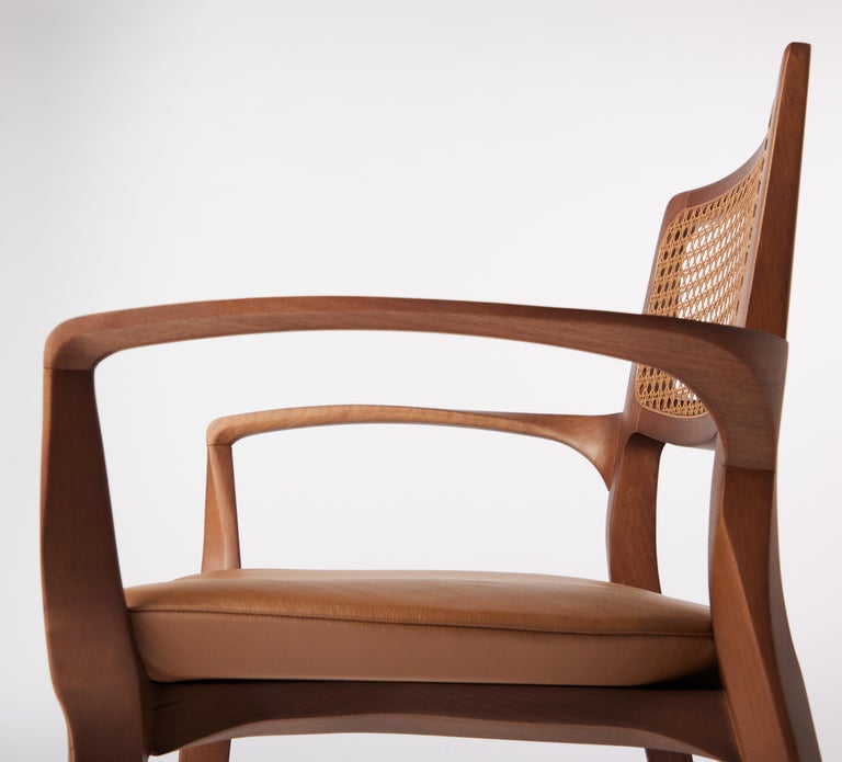 https://a.1stdibscdn.com/post-modern-style-aurora-chair-in-sculpted-walnut-finish-with-cane-and-leather-for-sale-picture-6/f_35593/f_299044221659978232012/2022_06_09_Daniel_Simonini20069_master.jpg?width=768