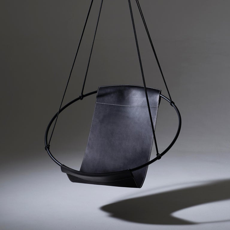 https://a.1stdibscdn.com/sling-hanging-swing-chair-genuine-black-leather-21st-century-modern-for-sale-picture-4/f_32773/f_95536231610228562133/5_Sling_Black_with_Bolster_no_bolster_mood_master.jpg?width=768
