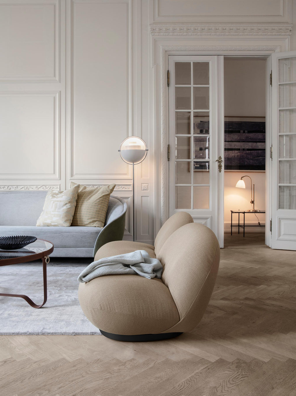 https://a.1stdibscdn.com/large-jacques-adnet-circulaire-glass-and-black-leather-coffee-table-for-gubi-for-sale-picture-8/f_14472/f_365626021697037003048/AdnetCoffeeTableCircular_MategotBowl_PachaLoungeChair_ReversSofa_Multi_LiteLamp_TSConsole_BL1TableLamp_on_master.jpg