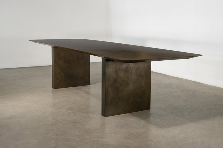 https://a.1stdibscdn.com/sculptural-twin-pedestal-patinated-steel-dining-table-andre-fierro-x-costantini-for-sale-picture-2/f_25173/f_482514521767973117595/Andre_Fierro_Table_Gun_Metal_Patinated_Steel_Twin_Pedestal_Dining_Table_by_Costantini_00_master.jpg?width=768