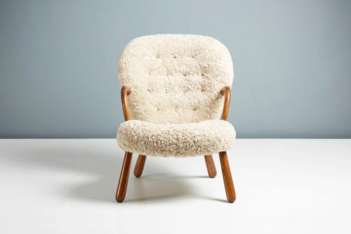 https://a.1stdibscdn.com/re-edition-sheepskin-clam-chair-by-arnold-madsen-for-sale-picture-2/f_13332/f_300195621660734863660/ArnoldMadsen_Dagmar_ClamChairREPRO_MoonlightOiledOak_03_copy_master.jpg