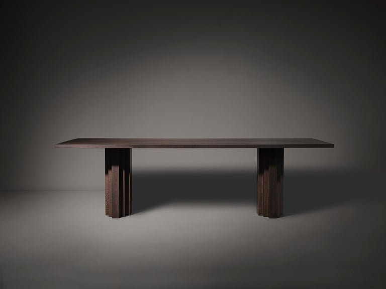 https://a.1stdibscdn.com/minimalist-solid-oak-wooden-brut-slim-dining-table-for-sale-picture-5/f_89302/f_352861721726488136047/Brut_Slim_Table_Dark_Brown_I_Oak_Front_View_photo_by_Thomas_van_Schaik_master.jpg?width=768