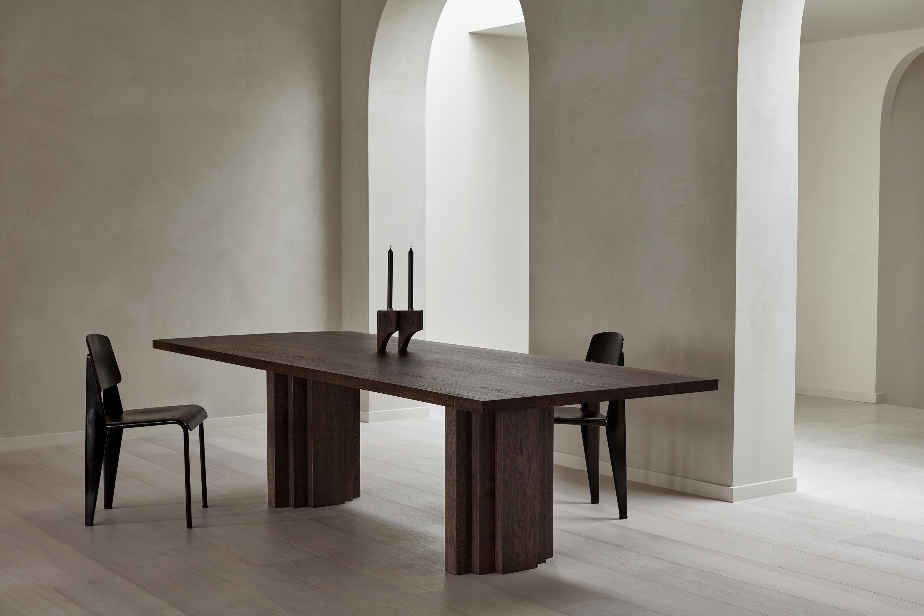 https://a.1stdibscdn.com/large-mokko-dining-table-in-solid-french-oak-for-sale-picture-10/f_89302/f_429557821735654917218/Brut_Slim_Table_and_Acer_Candle_Holder_R_2_Dark_Brown_I_Oak_setting_Achtergracht_photo_by_Thomas_van_Schaik_master.jpg
