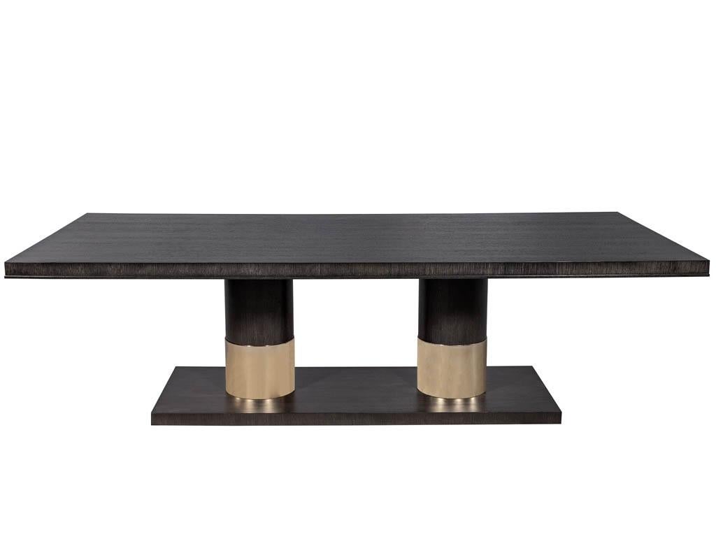 https://a.1stdibscdn.com/modern-oak-dining-table-with-double-column-champagne-ring-base-for-sale-picture-2/f_8849/1593197721564/DS_5123_Modern_Oak_Double_Pedestal_Brass_Ring_Dining_Table_002_master.jpg