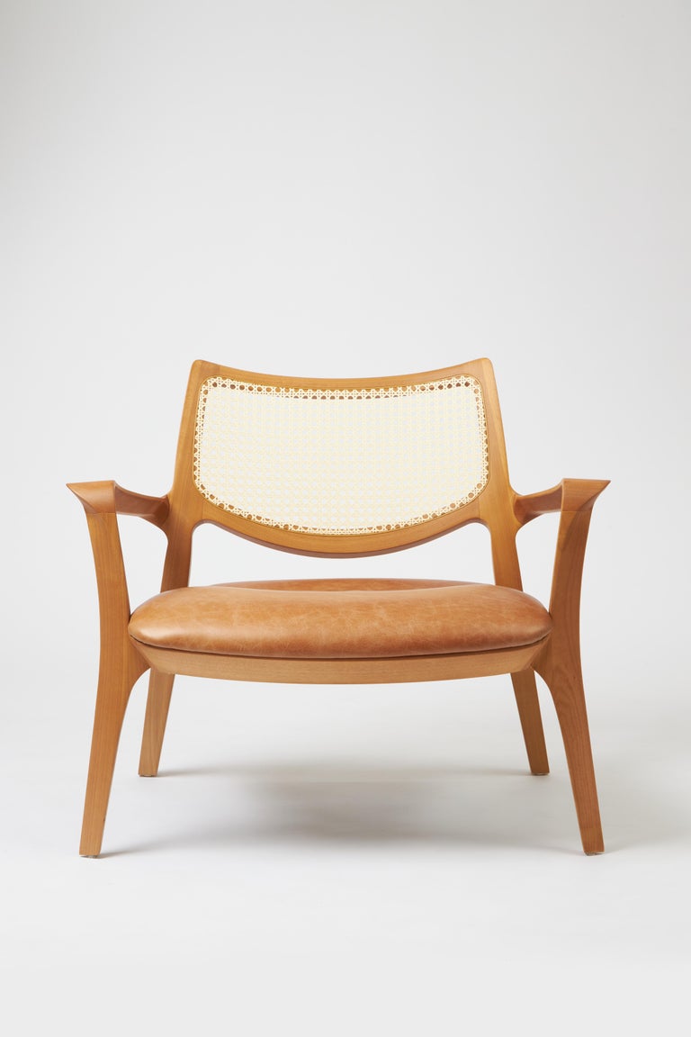 https://a.1stdibscdn.com/modern-style-aurora-armchair-sculpted-in-solid-wood-caning-back-leather-seat-for-sale-picture-2/f_35593/f_390934521711999364896/Emp_rio_das_Cadeiras0741_master.jpg?width=768