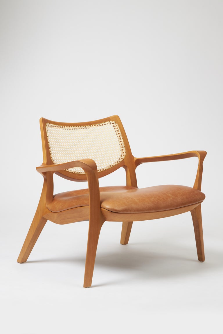https://a.1stdibscdn.com/modern-style-aurora-armchair-sculpted-in-solid-wood-caning-back-leather-seat-for-sale-picture-2/f_35593/f_390931821711998761635/Emp_rio_das_Cadeiras0742_master.jpg?width=768