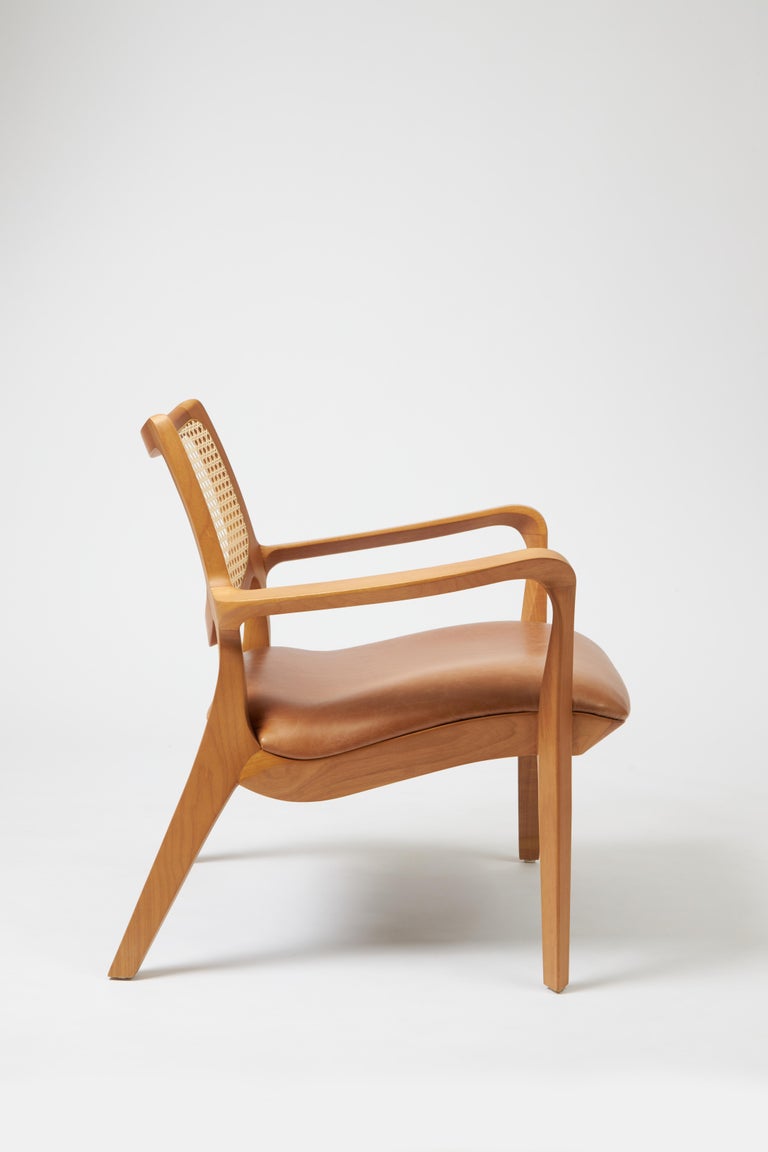 https://a.1stdibscdn.com/modern-style-aurora-armchair-sculpted-in-solid-wood-caning-back-leather-seat-for-sale-picture-3/f_35593/f_390934521711999275976/Emp_rio_das_Cadeiras0743_master.jpg?width=768