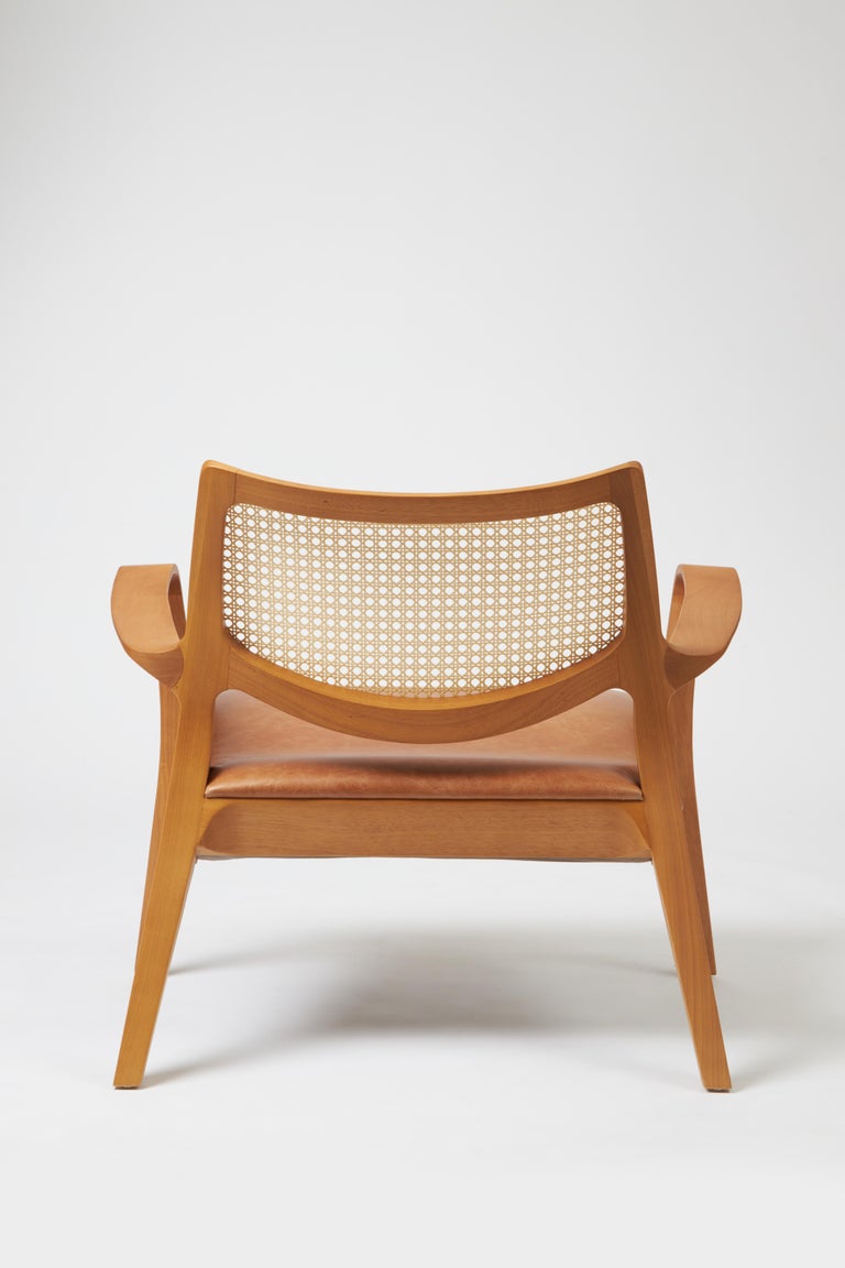 https://a.1stdibscdn.com/modern-style-aurora-armchair-sculpted-in-solid-wood-caning-back-leather-seat-for-sale-picture-5/f_35593/f_390934521711999277880/Emp_rio_das_Cadeiras0744_master.jpg?width=768