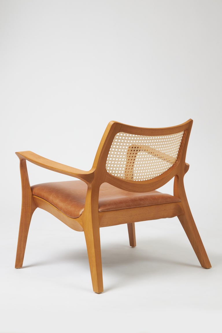 https://a.1stdibscdn.com/modern-style-aurora-armchair-sculpted-in-solid-wood-caning-back-leather-seat-for-sale-picture-4/f_35593/f_390934521711999277002/Emp_rio_das_Cadeiras0745_master.jpg?width=768