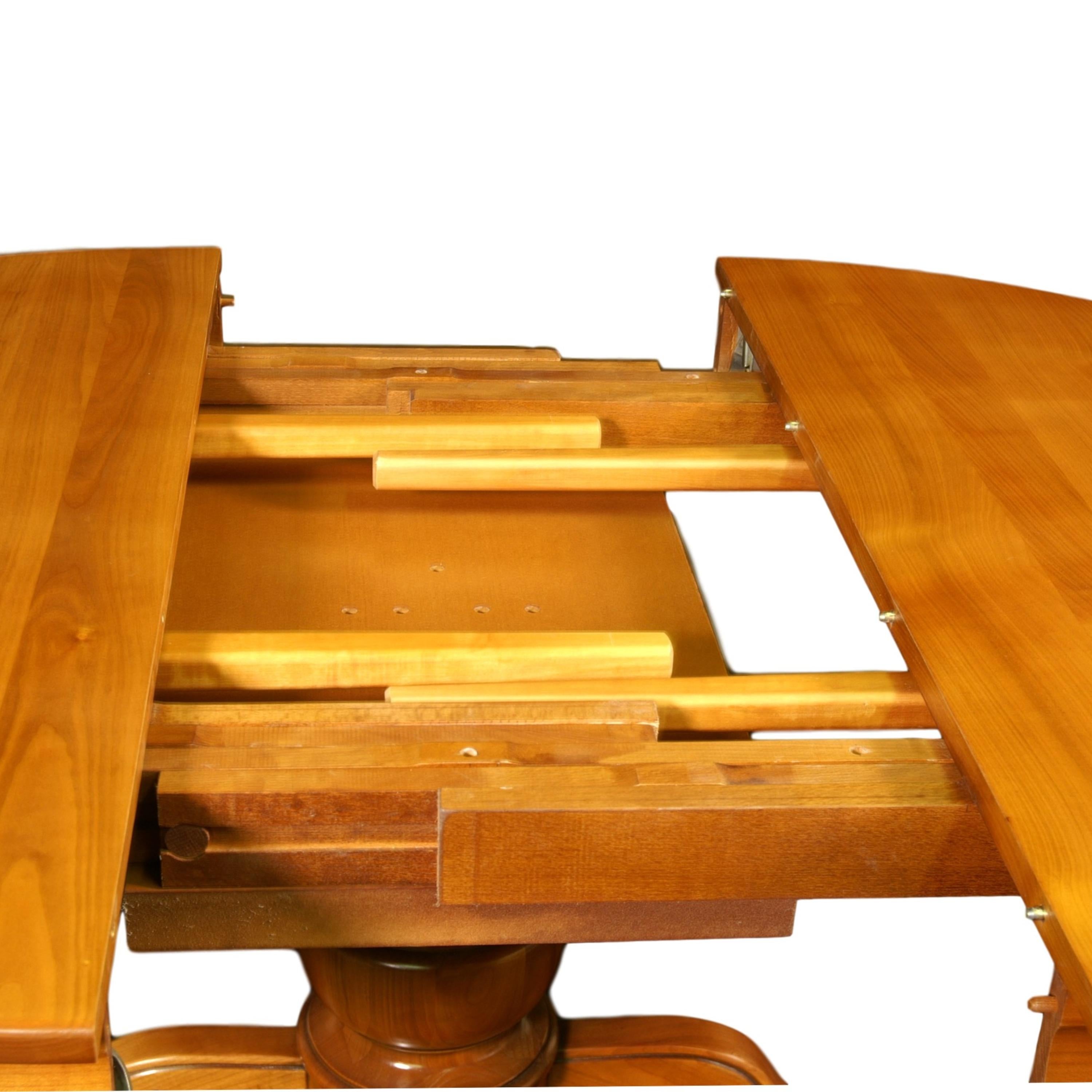 https://a.1stdibscdn.com/round-table-with-a-central-foot-and-2-extensions-in-solid-cherry-for-sale-picture-5/f_57342/f_264612821639063393739/FLA_5703M_ex_1852_table_ronde_merisier_f_t_central_d_tail_ouverture_plateau_3000x3000_master.jpeg