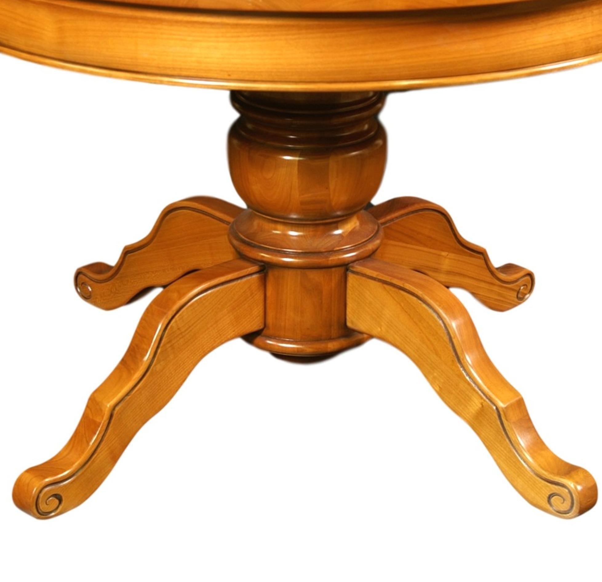 https://a.1stdibscdn.com/round-table-with-a-central-foot-and-2-extensions-in-solid-cherry-for-sale-picture-4/f_57342/f_264612821639063390774/FLA_5703M_ex_1852_table_ronde_merisier_f_t_central_d_tail_pied_central_1957x1957_master.jpeg