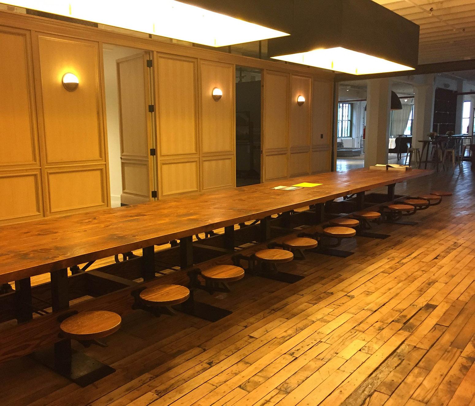 https://a.1stdibscdn.com/eight-seat-communal-steel-top-dining-table-with-cast-iron-attached-swing-seats-for-sale-picture-13/f_8299/f_10364141538056527884/GetBackInc_Swing_out_Seat_Communal_Table_Brooklyn_1_master.jpg