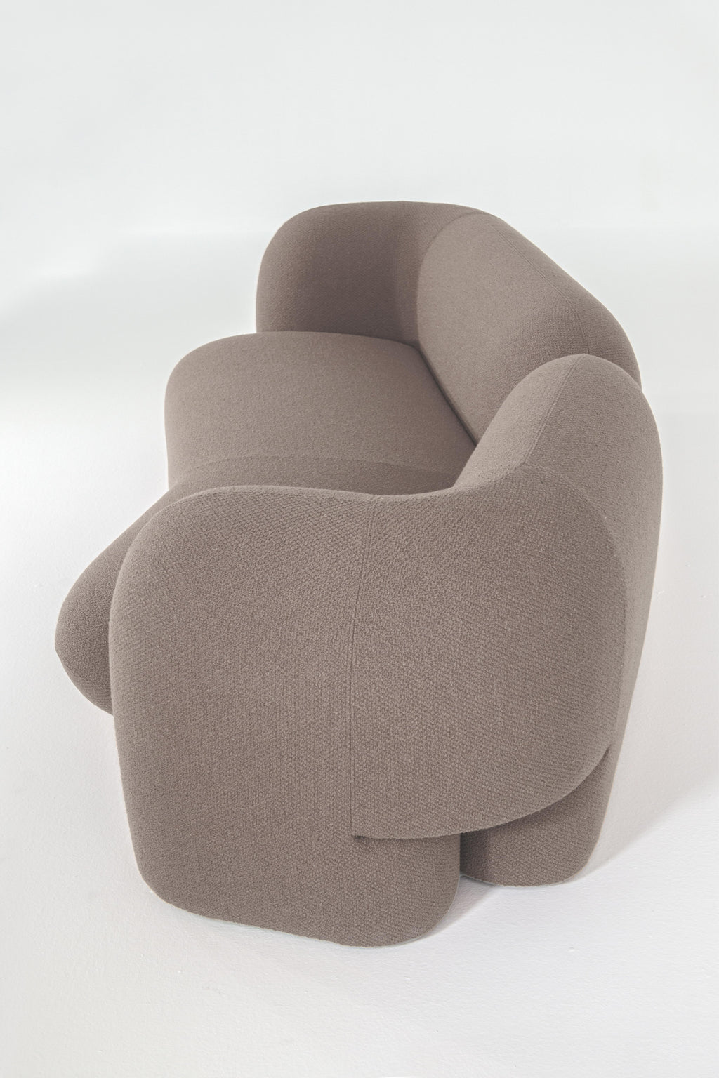 https://a.1stdibscdn.com/contemporary-curve-three-seater-sofa-by-hessentia-in-boucle-fabric-mink-colour-for-sale-picture-3/f_57252/f_359578521694686150069/Gio_ang_2_master.jpg
