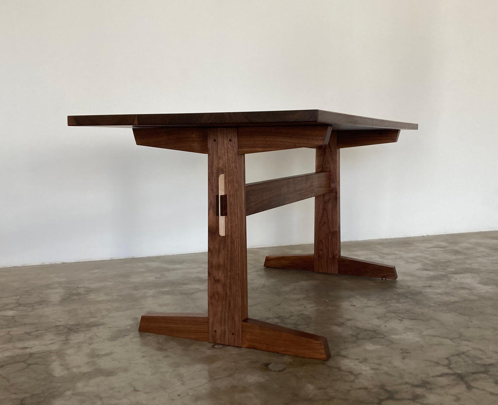 https://a.1stdibscdn.com/hana-walnut-trestle-dining-table-in-stock-for-sale-picture-6/f_49771/f_428426721734641627176/Hana_Trestle_San_Leandro_1_master.jpg