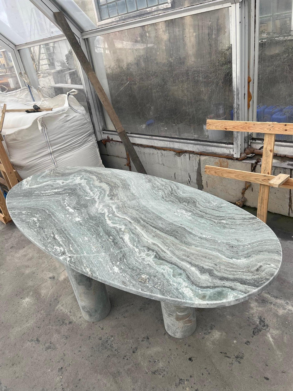 https://a.1stdibscdn.com/large-solid-stone-green-marble-oval-dining-table-with-column-legs-for-sale-picture-4/f_80522/f_32423352/IMG_1675951403045_master.jpg