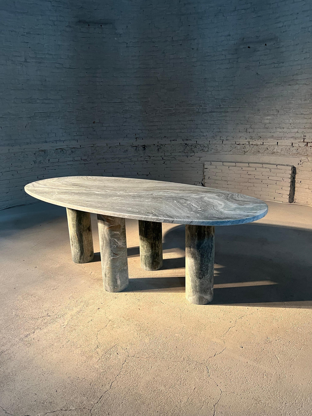 https://a.1stdibscdn.com/large-solid-stone-green-marble-oval-dining-table-with-column-legs-for-sale-picture-3/f_80522/f_32423352/IMG_1677438862193_master.jpg