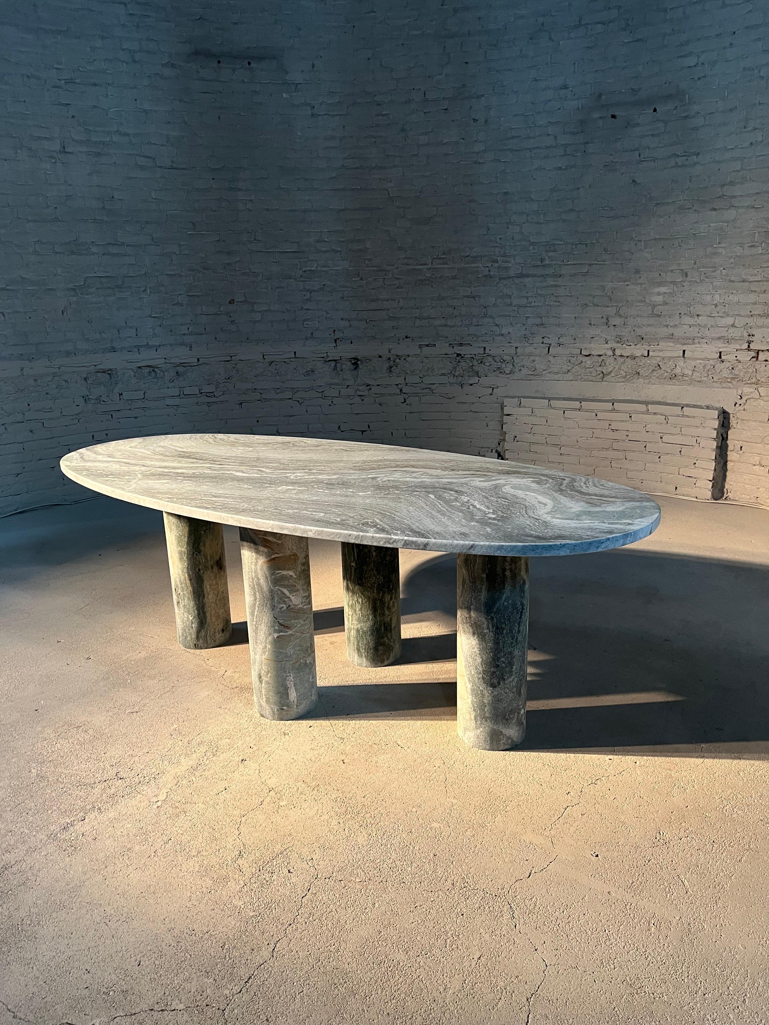 https://a.1stdibscdn.com/large-solid-stone-green-marble-oval-dining-table-with-column-legs-for-sale-picture-3/f_80522/f_32423352/IMG_1677438862193_master.jpg