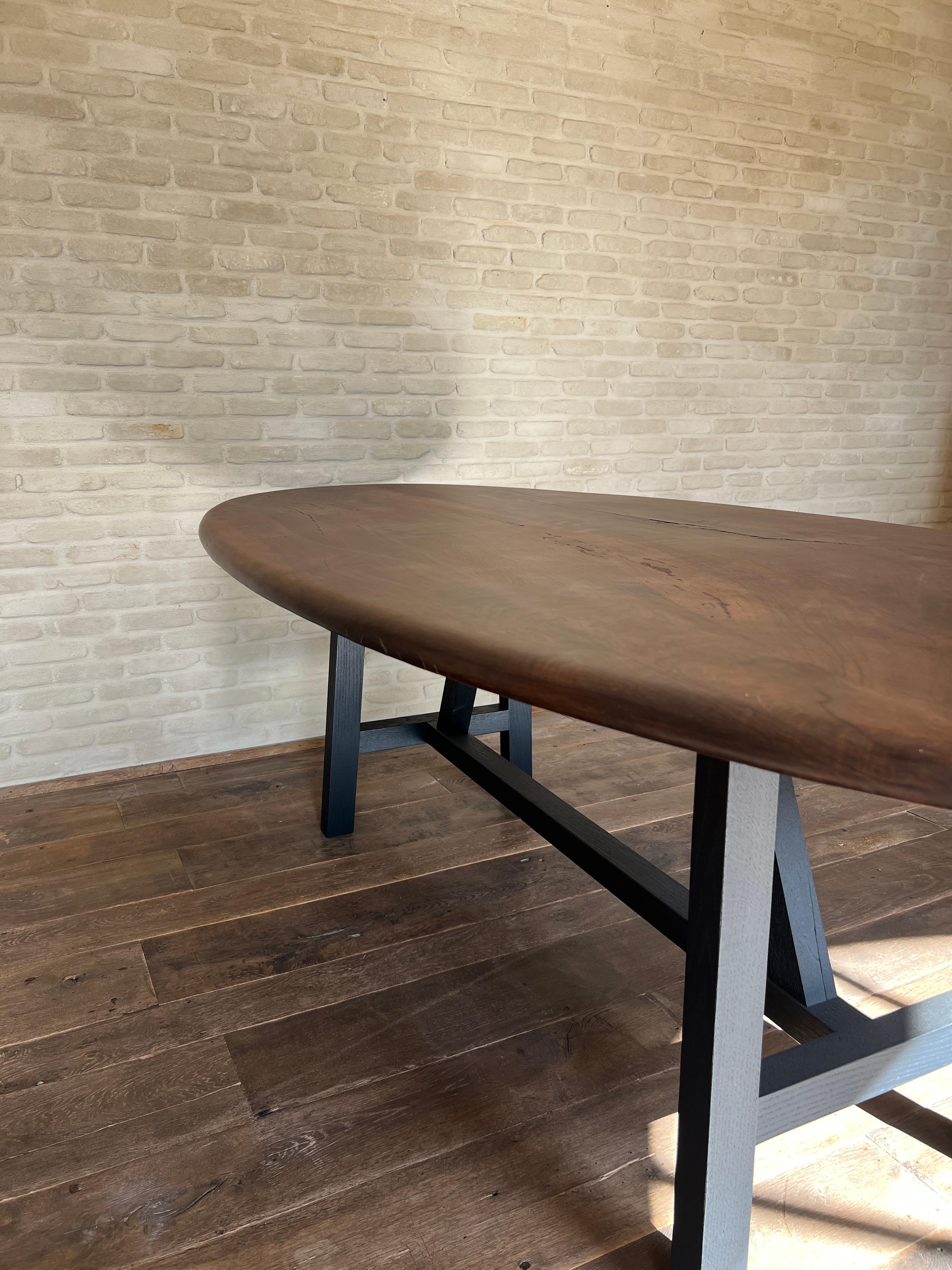 https://a.1stdibscdn.com/custom-walnut-2-plank-top-oval-dining-table-model-lusi-dark-finish-for-sale-picture-5/f_20233/f_47011632/IMG_1760212978944_master.JPG