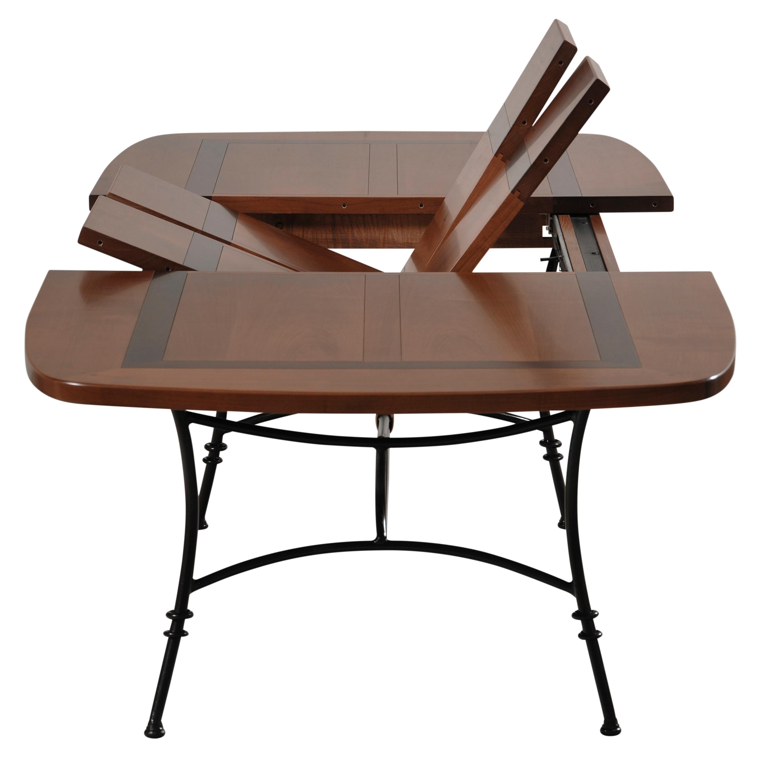 https://a.1stdibscdn.com/wrought-iron-table-with-solid-cherry-top-integrated-extensions-for-sale-picture-2/f_57342/f_404705721720088030311/MEL_5703MDN_Table_ovalis_e_merisier_D_et_cadre_noir_face_2_allonges_relev_es_3000x3000_master.jpg