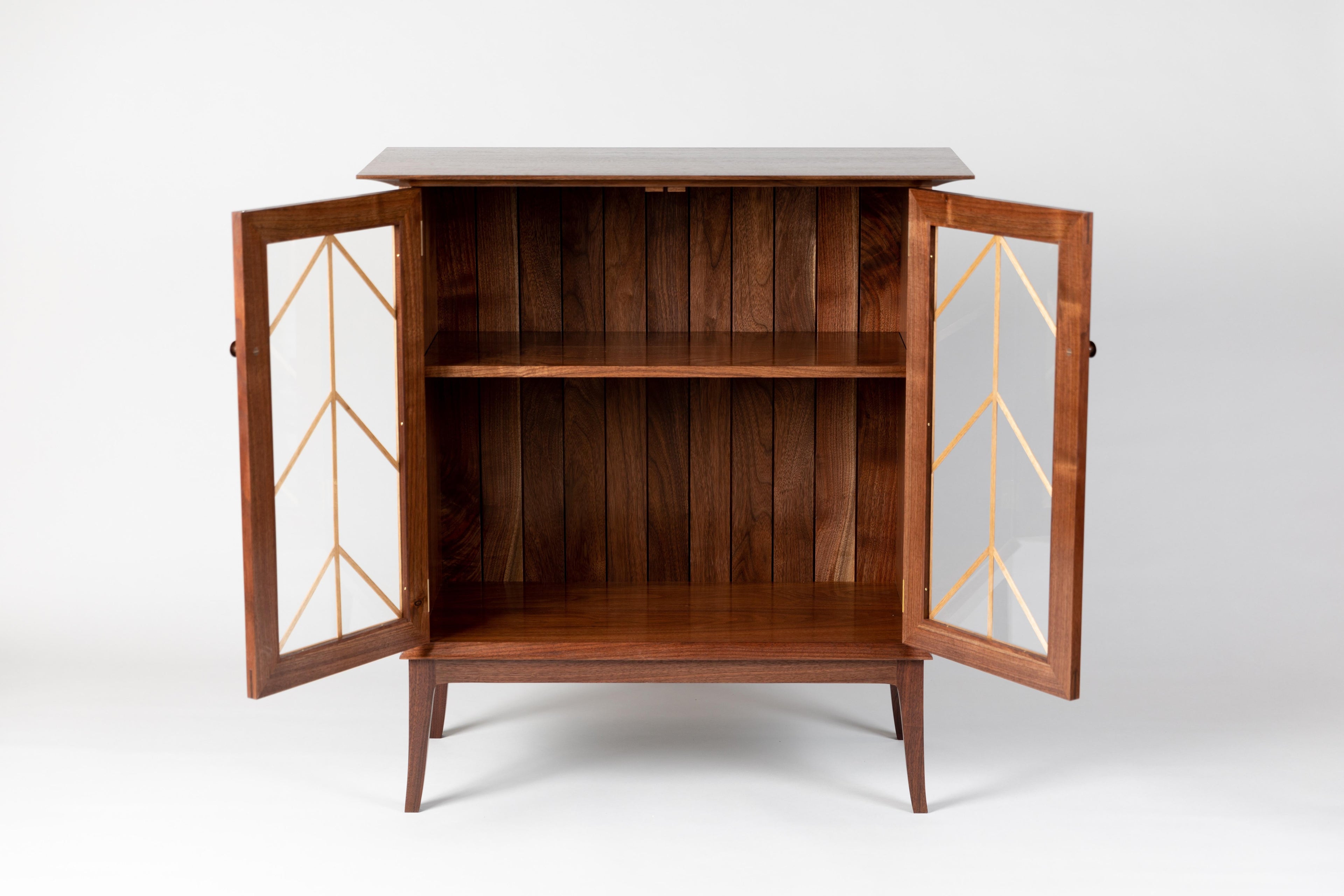 https://a.1stdibscdn.com/contemporary-walnut-cabinet-with-glass-doors-and-butternut-details-for-sale-picture-2/f_38643/1571942182933/MMH20191001_01_master.jpg