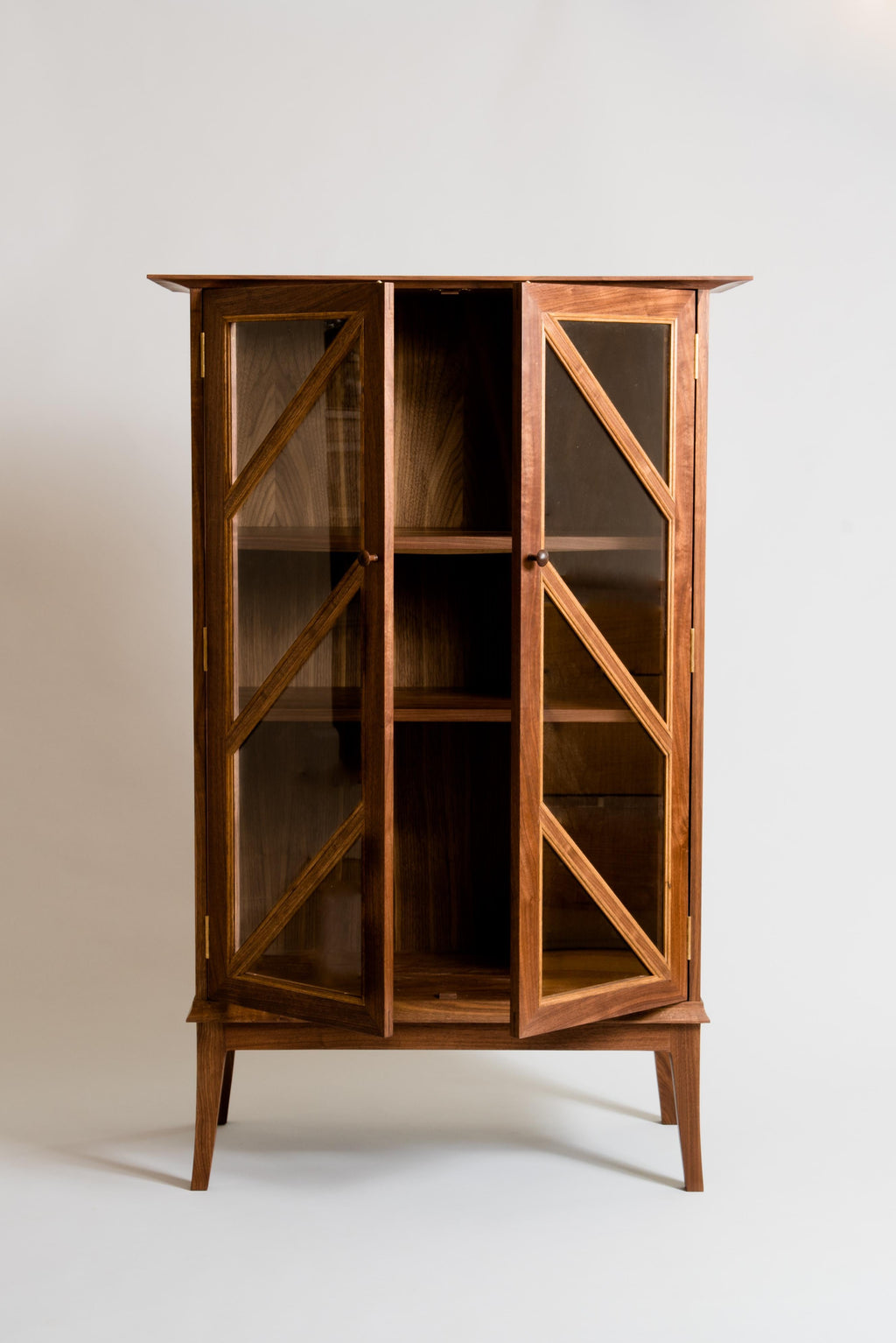 https://a.1stdibscdn.com/tall-contemporary-walnut-cabinet-with-glass-doors-and-butternut-details-for-sale-picture-2/f_38643/1571241050250/MeredithHartFurnitureCabinet2_master.jpg