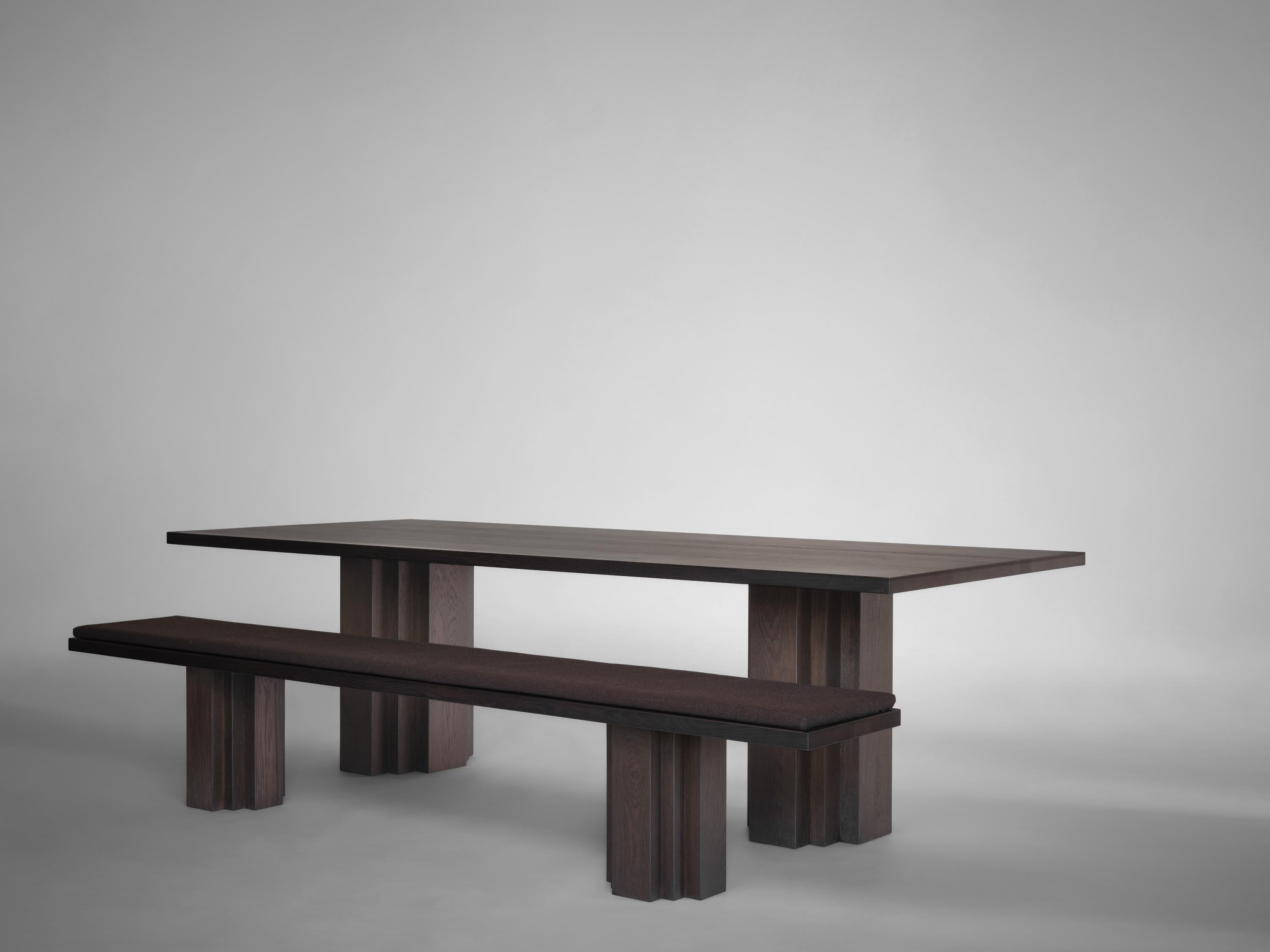 https://a.1stdibscdn.com/large-sculptural-brut-dining-table-solid-oak-for-sale-picture-20/f_89302/f_380659521756377611645/Mokko_Brut_table_Brut_bench_Dark_Brown_Oak_light_grey_side_view_photo_by_Thomas_van_Schaik_master.jpg