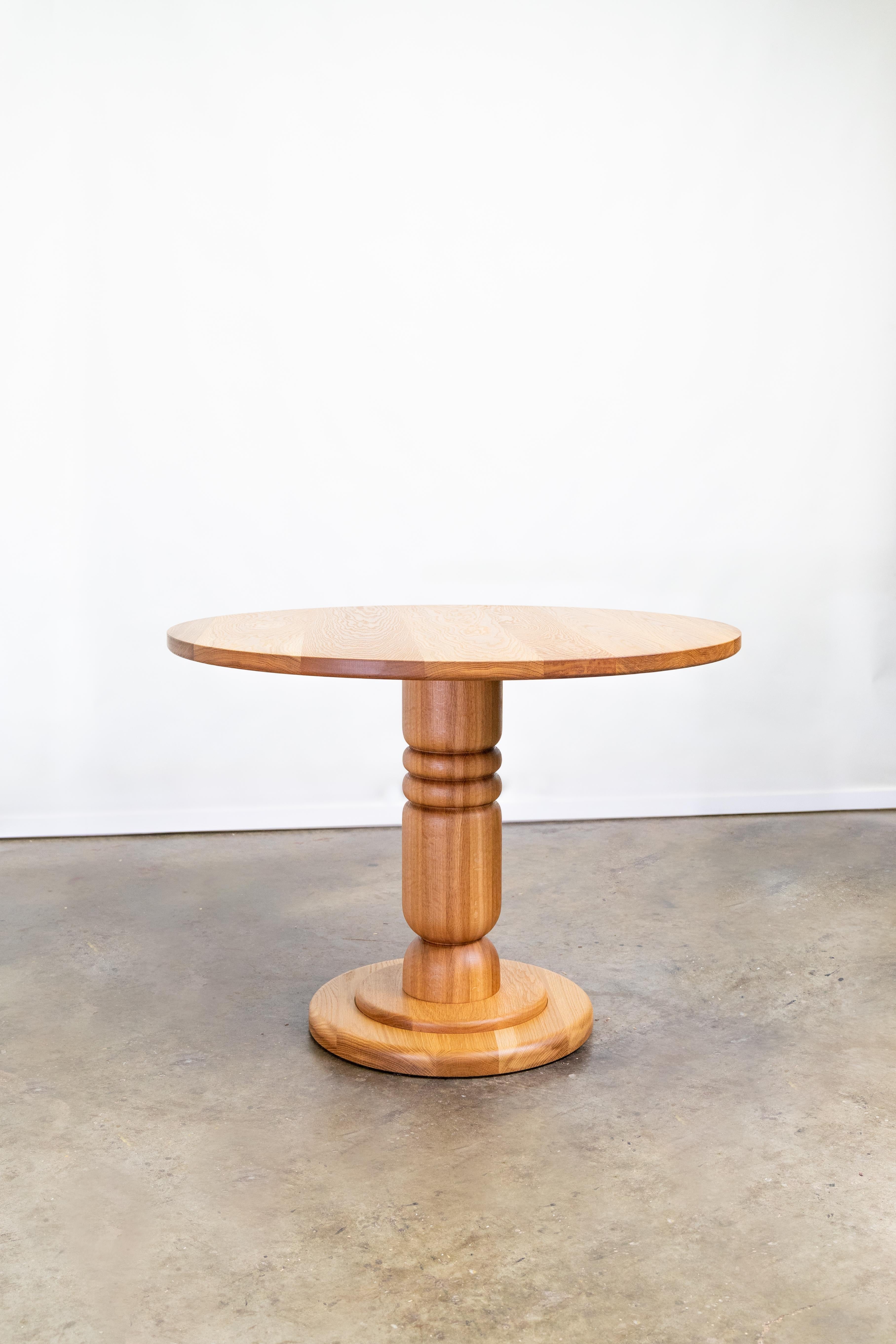 https://a.1stdibscdn.com/hand-turned-pedestal-table-in-solid-oak-or-walnut-for-sale-picture-4/f_106752/f_472556521761699608419/Storie_Collective_Round_Dining_Table_1_HiRes_master.jpg