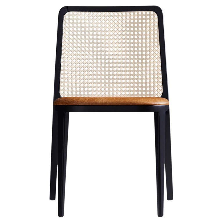 https://a.1stdibscdn.com/wing-chair-by-designer-simonini-ebonized-solid-wood-leather-caning-for-sale/f_35593/f_162313121775602224539/f_16231312_1775602224656_bg_processed.jpg?width=768
