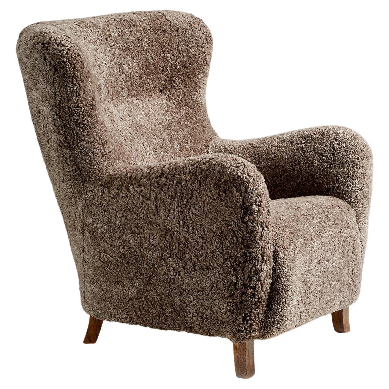https://a.1stdibscdn.com/custom-made-sheepskin-wing-chair-for-sale/f_13332/f_259762721635983124768/f_25976272_1635983125194_bg_processed.jpg