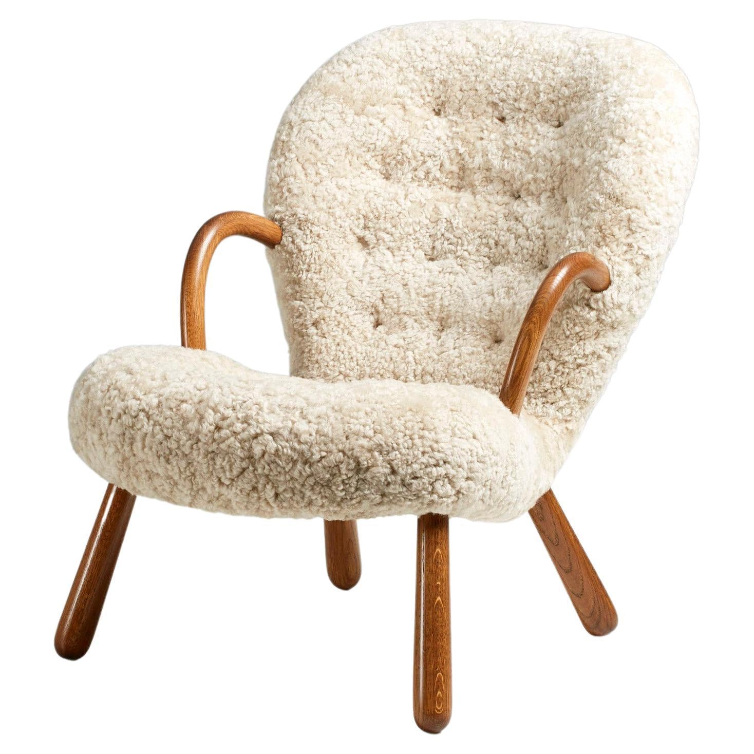 https://a.1stdibscdn.com/re-edition-sheepskin-clam-chair-by-arnold-madsen-for-sale/f_13332/f_300195621660734862634/f_29060132_1654877426109_bg_processed.jpg