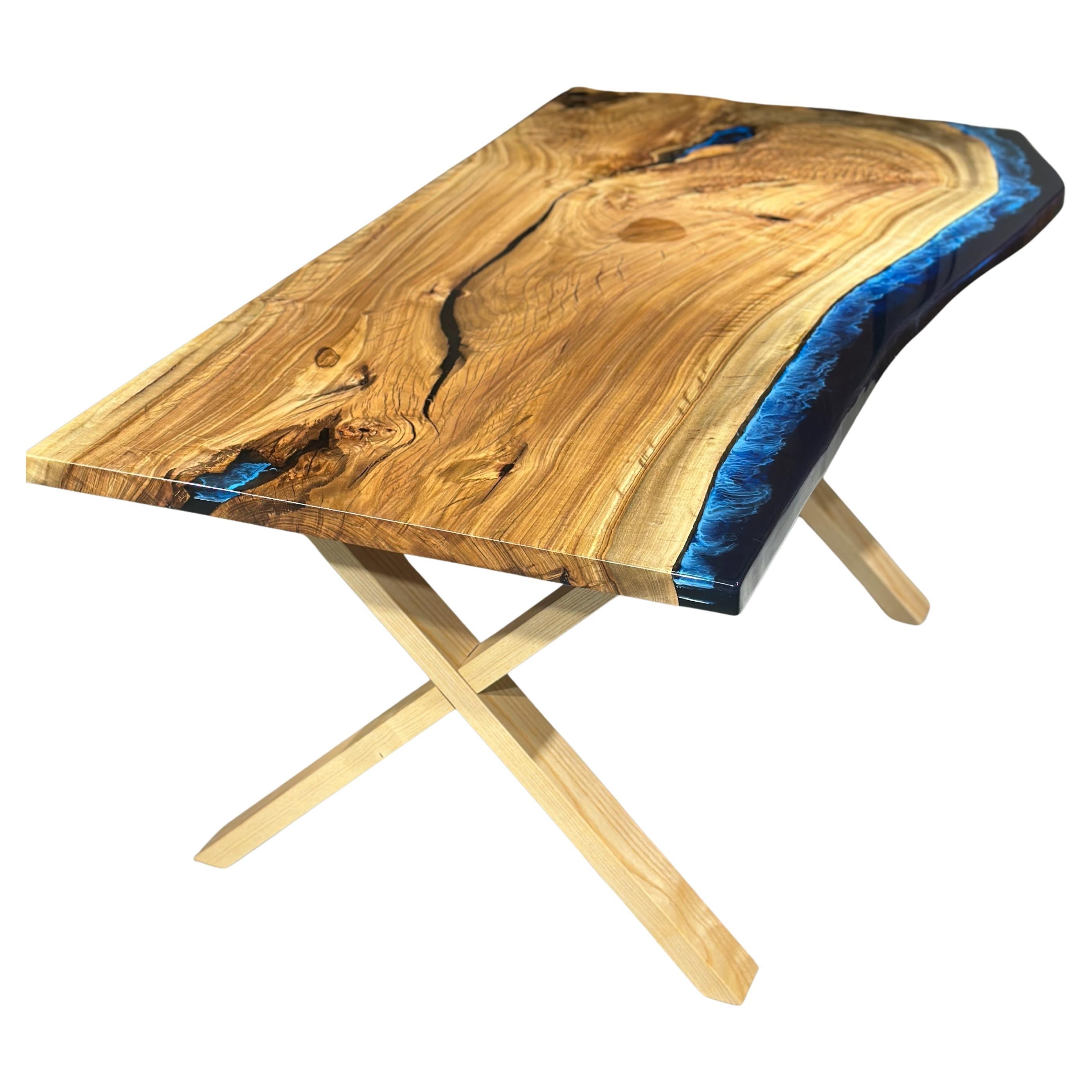 https://a.1stdibscdn.com/blue-resin-light-wood-dining-table-blue-epoxy-table-for-sale-picture-3/f_91932/f_368984521728099553422/f_36898452_1728099554587_bg_processed.jpg