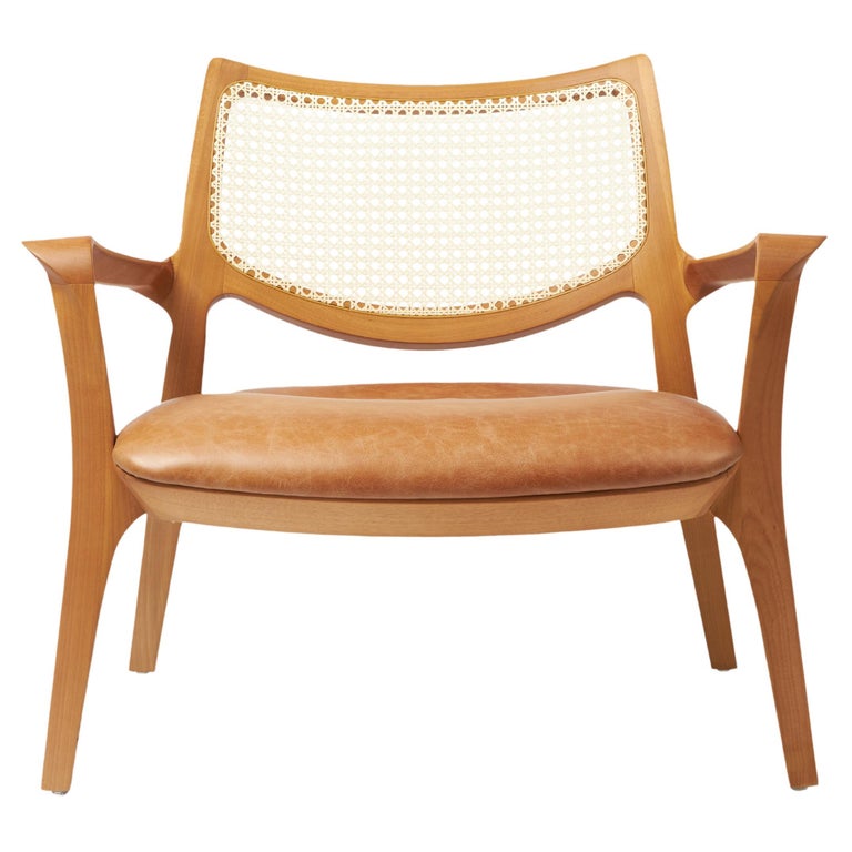 https://a.1stdibscdn.com/modern-style-aurora-armchair-sculpted-in-solid-wood-caning-back-leather-seat-for-sale/f_35593/f_390931821711998852573/f_39093182_1711998853496_bg_processed.jpg?width=768