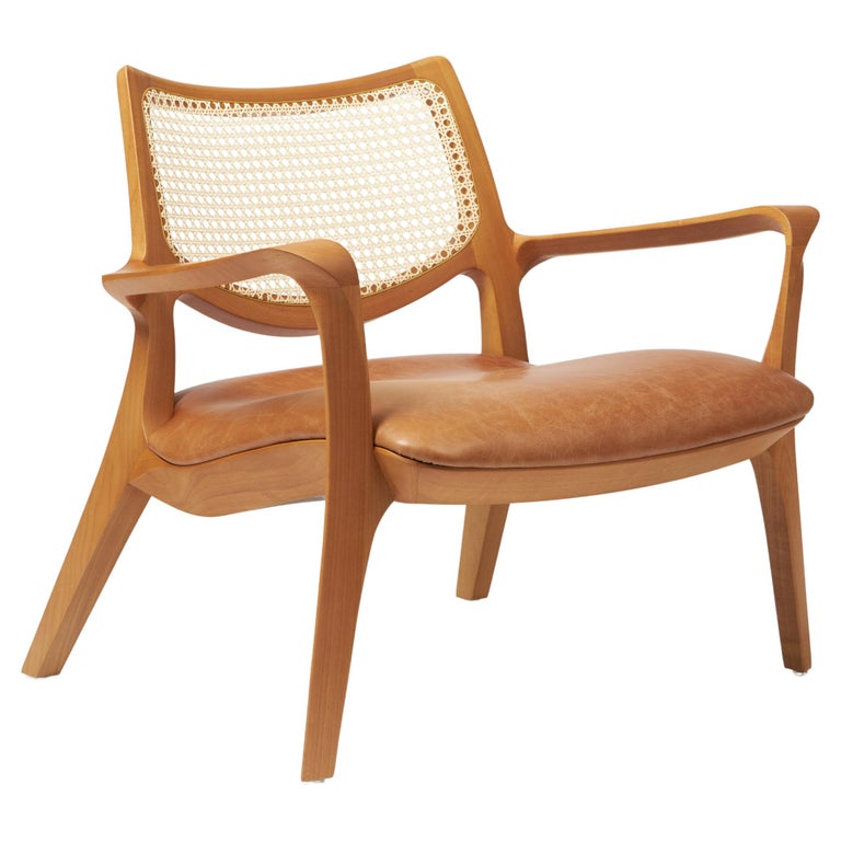 https://a.1stdibscdn.com/modern-style-aurora-armchair-sculpted-in-solid-wood-caning-back-leather-seat-for-sale/f_35593/f_390934521711999328658/f_39093452_1711999329582_bg_processed.jpg?width=768