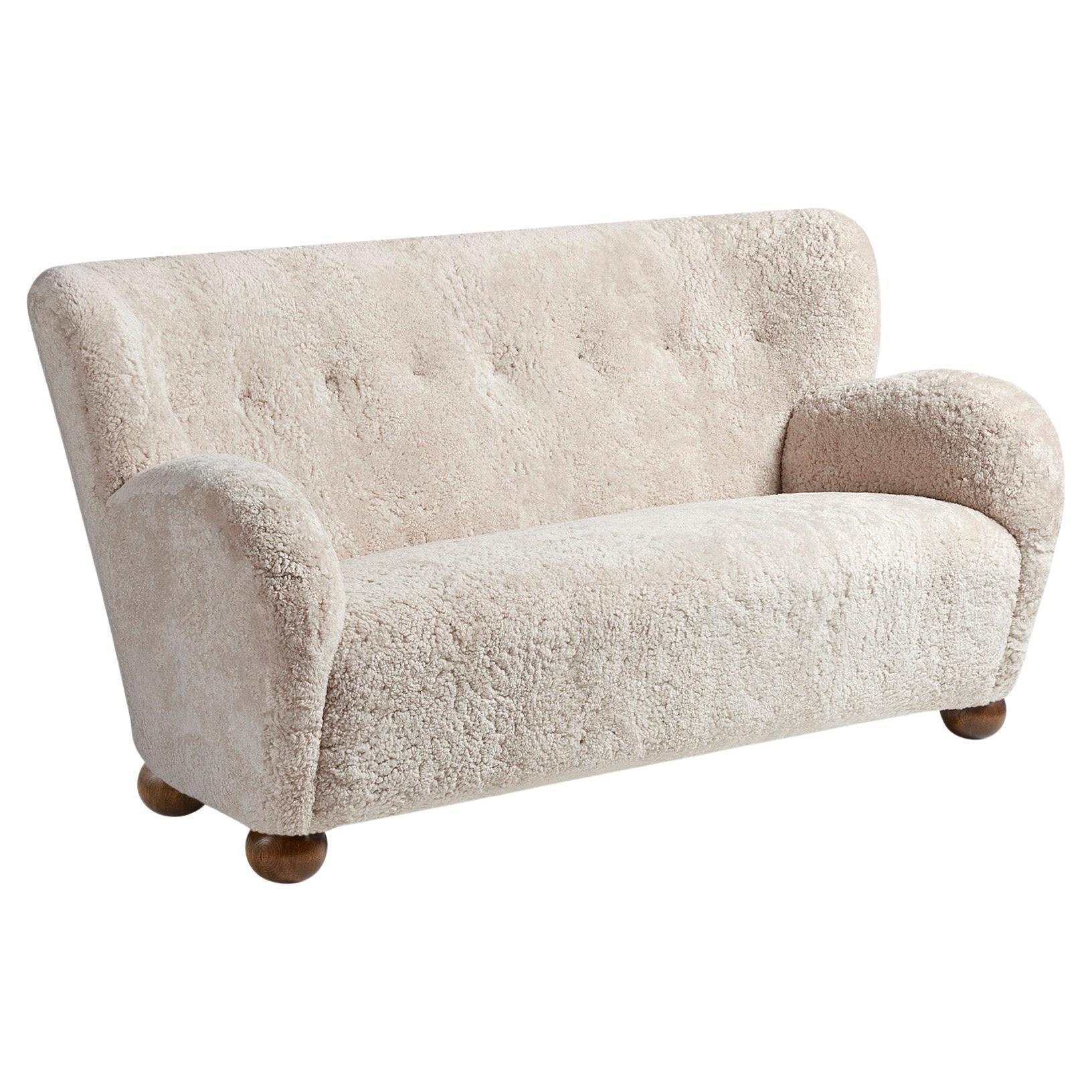 https://a.1stdibscdn.com/custom-made-sheepskin-karu-sofa-with-ball-feet-by-dagmar-for-sale/f_13332/f_450213021747228932502/f_45021302_1747228933028_bg_processed.jpg