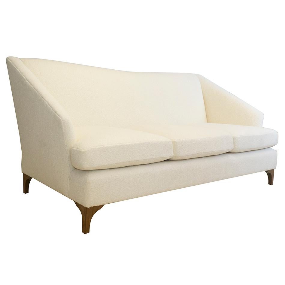 https://a.1stdibscdn.com/tall-back-tight-back-winged-sofa-with-walnut-legs-and-wool-boucle-fabric-for-sale-picture-2/f_21233/1539637326158/whitesofa_angle_master.jpg